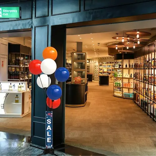 The same pavement sign with balloons at the entrance of a store